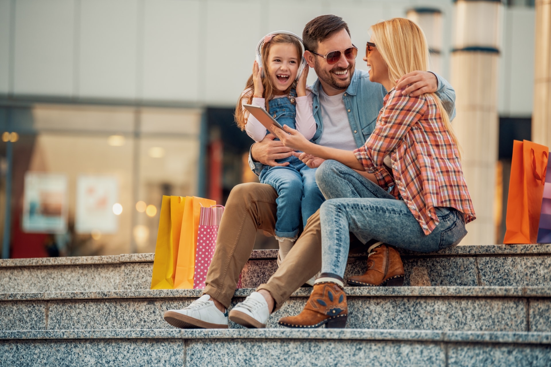 family sitting on steps, smiling