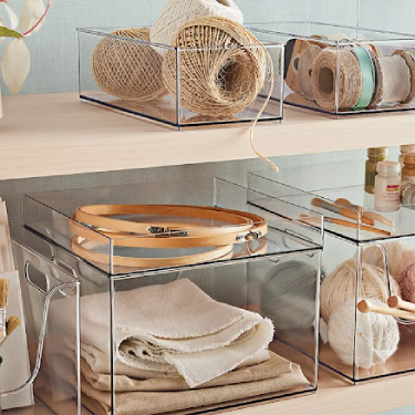 Storage containers with yarn, belts, towels, and other household items