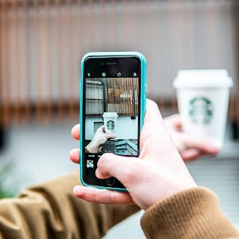 Starbucks Someone taking a picture of a starbucks cup